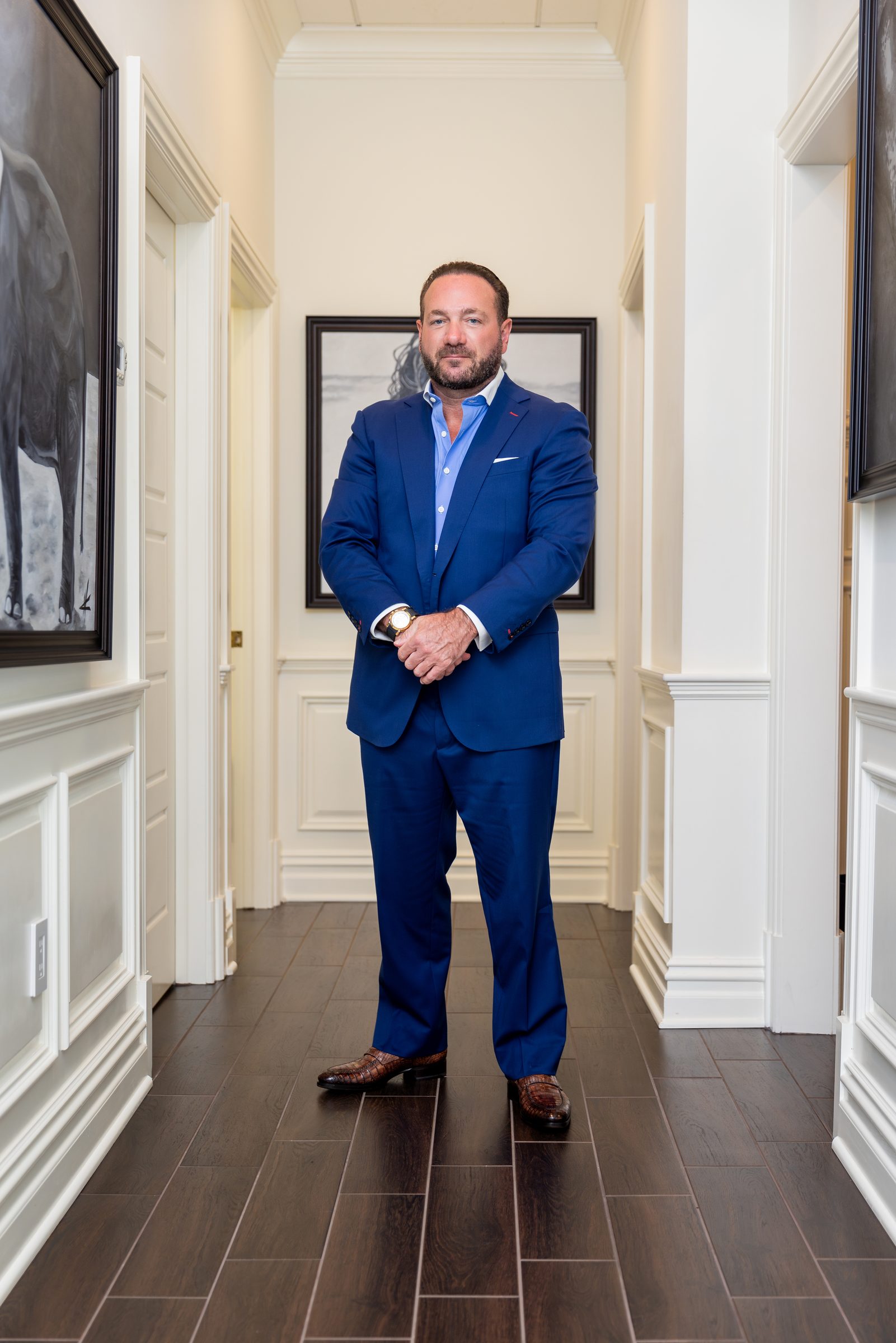 Portrait of Dr. Joseph Racanelli, board-certified plastic surgeon, at his New Jersey office desk