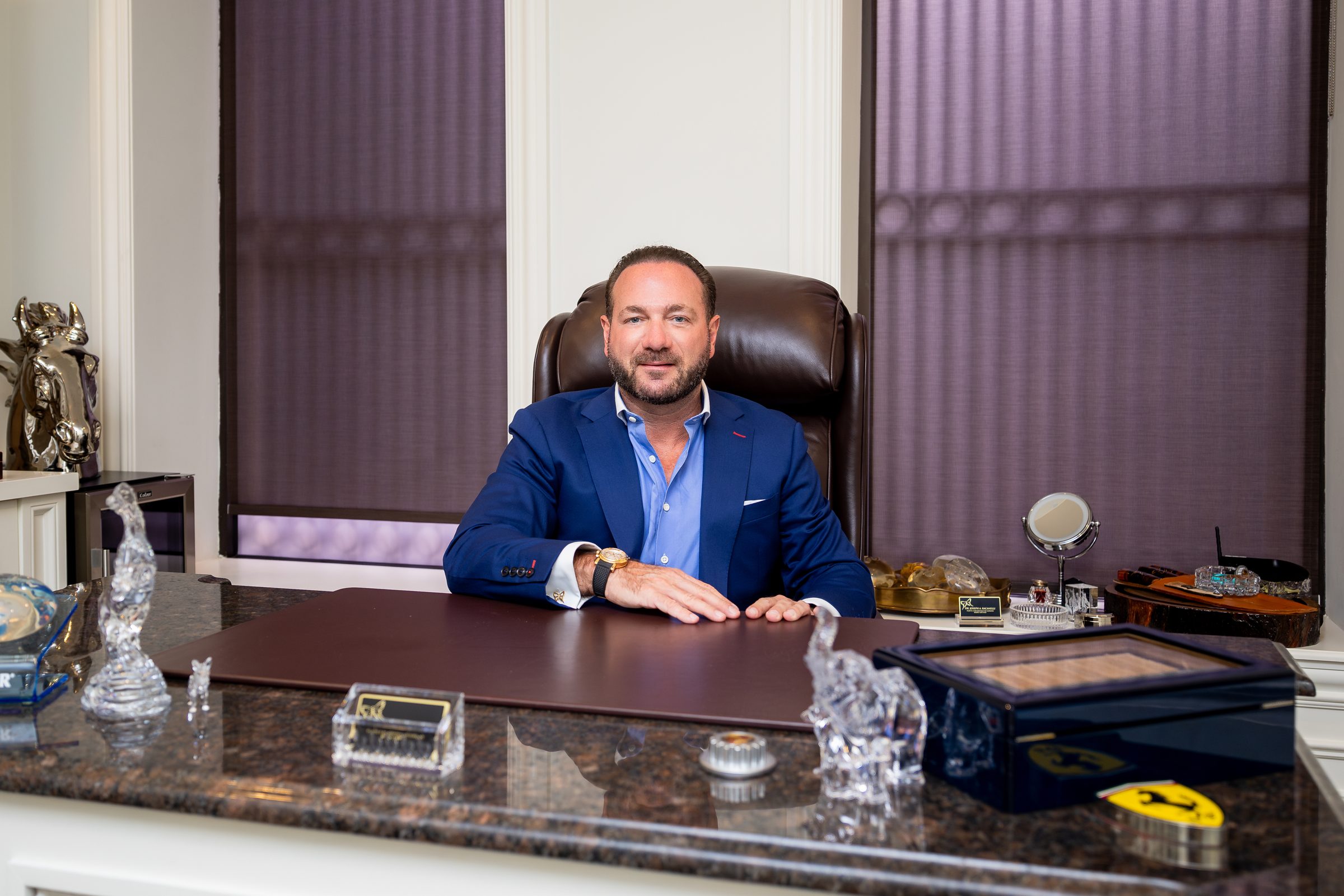 Dr. Joseph A. Racanelli, plastic surgeon, at his desk in his Morristown, NJ office